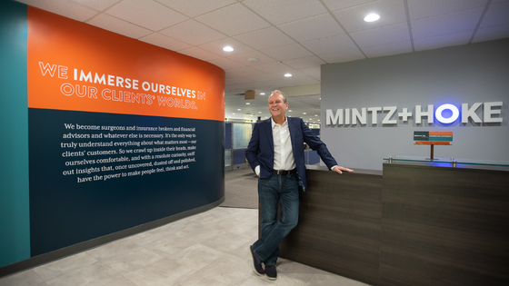 Mintz + Hoke CEO Ron Perine standing at front desk